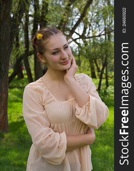 Portrait of a girl on the background of nature in spring