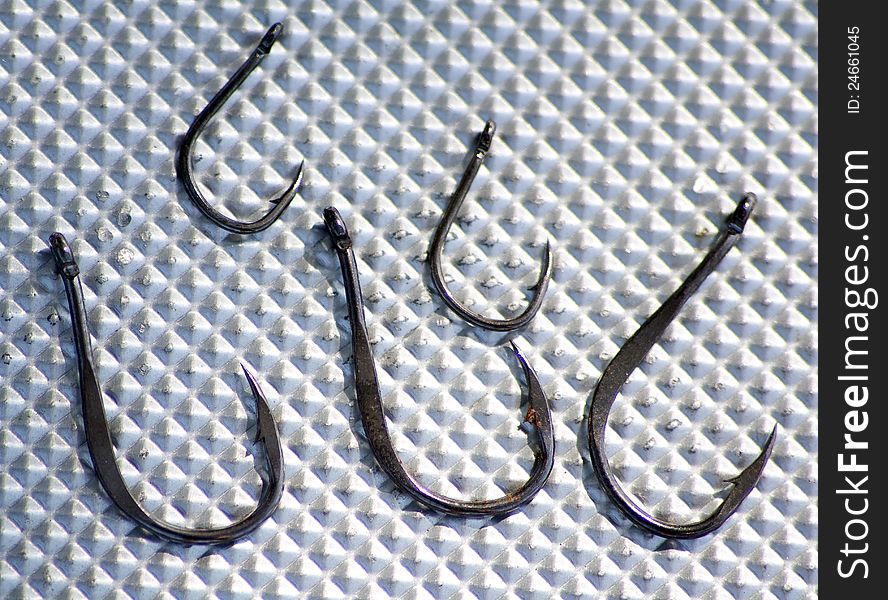 Different fishing hooks on white background