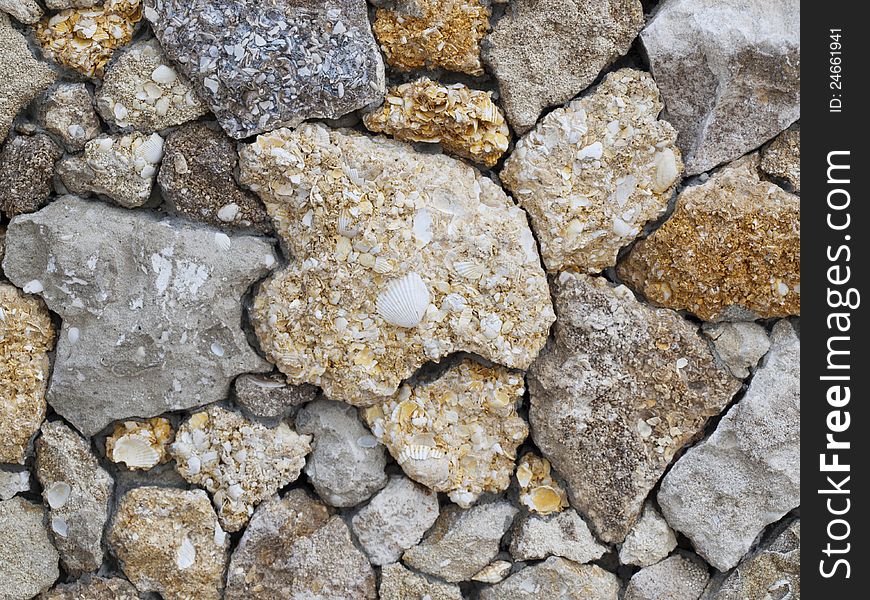 Fence of a natural building material of a yellow shell rock. Fence of a natural building material of a yellow shell rock