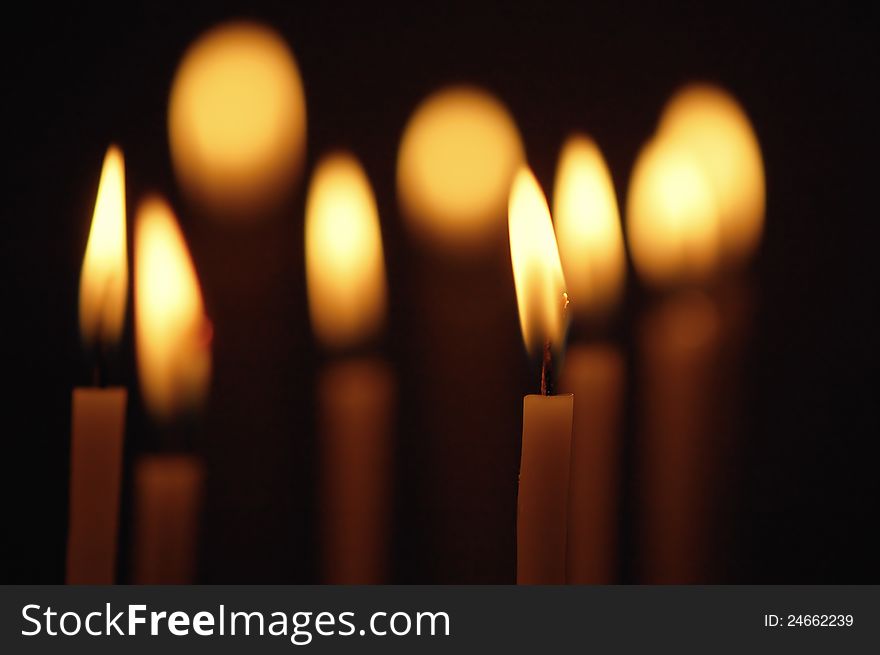 Discounted wax candles in the church. Background for design. Discounted wax candles in the church. Background for design