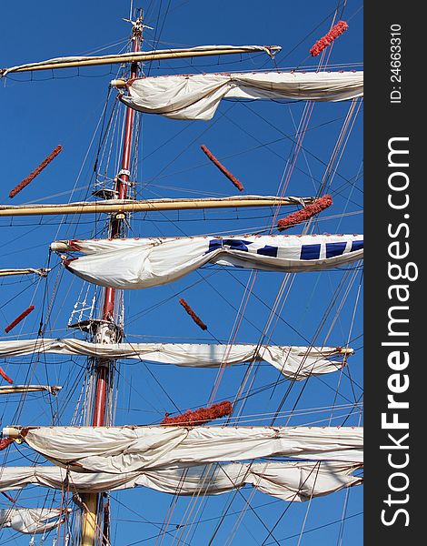 White sail frigate with three mast on the blue background