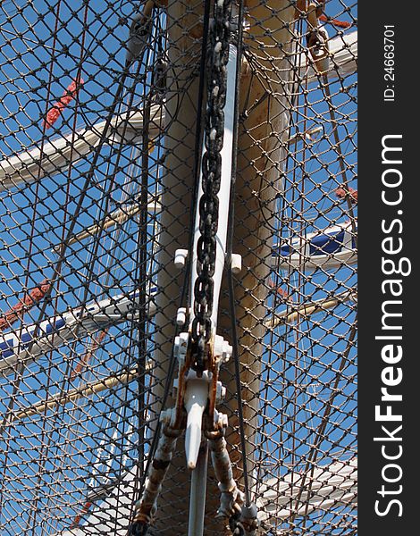 Net on the stern of frigate with three mast on the blue background