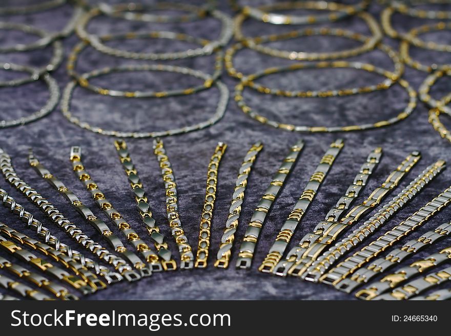 Gold necklaces and bracelets over purple velvet