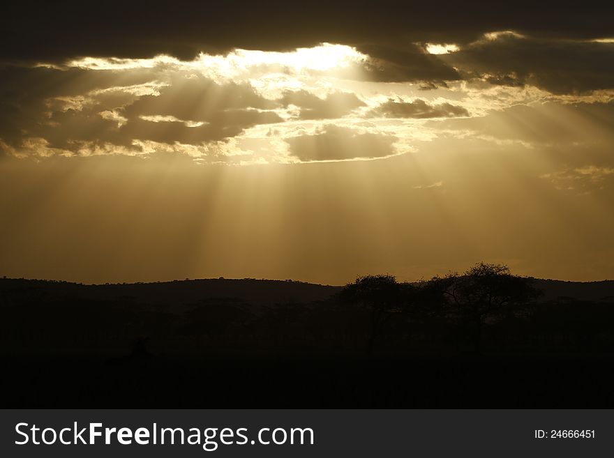 Shafts of light shine down through the clouds on a cloudy day. Shafts of light shine down through the clouds on a cloudy day.