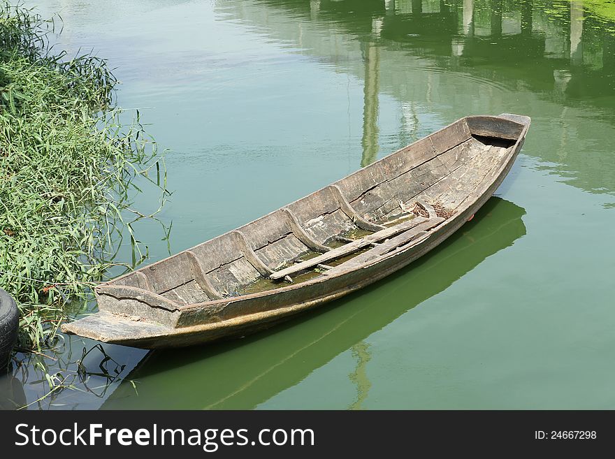 Old wooden boat in the canal at countryside of Thailand