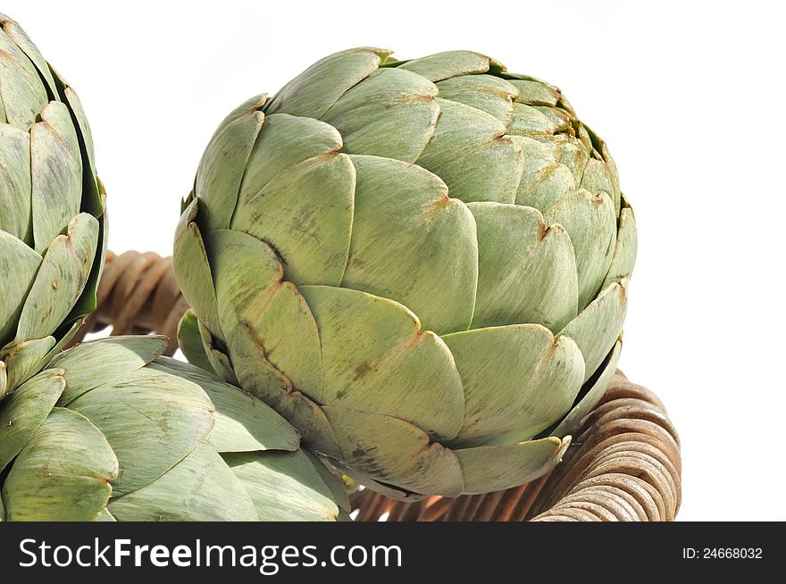 Artichokes in a basket on white background