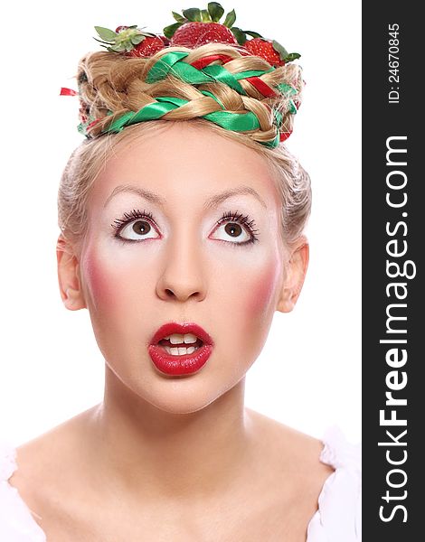 Woman with strawberry in her hairstyle over white background