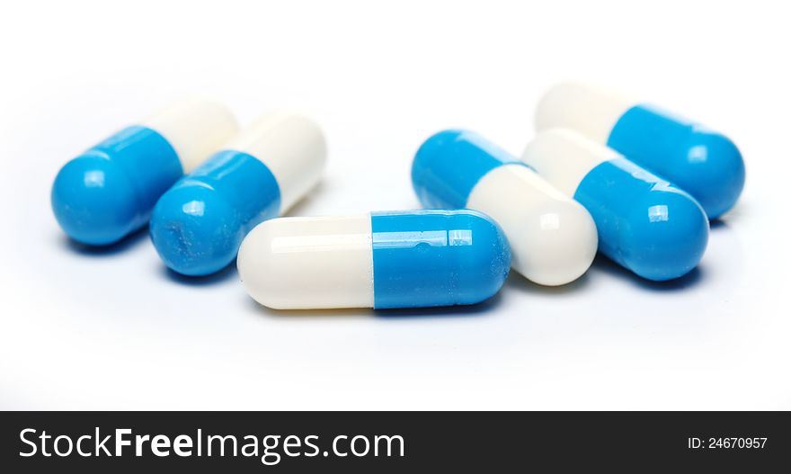 Close up of pills over white background