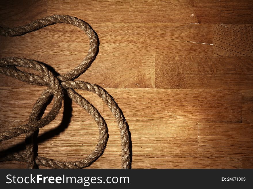 Old Rope Over Wooden Surface