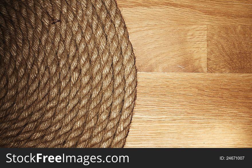 Old rope over wooden background. Old rope over wooden background