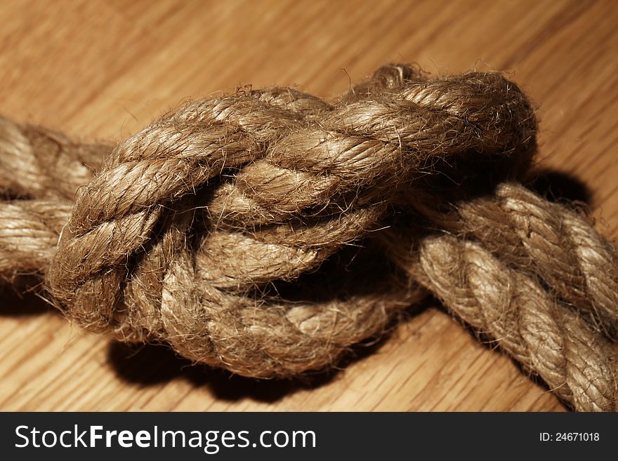 Old rope over wooden background. Old rope over wooden background