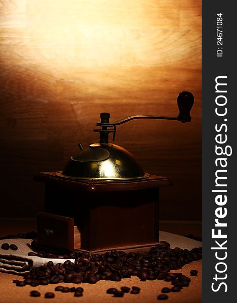 Old coffee grinder on wooden background