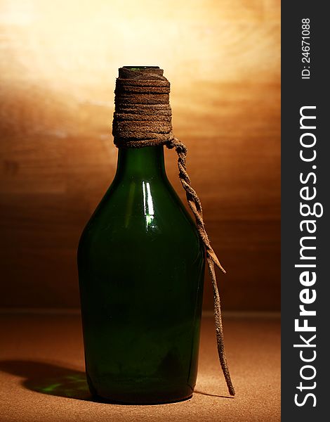 Old aged bottle over wooden surface