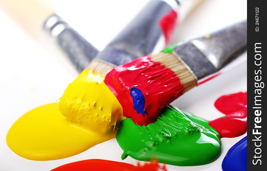 Close up of colorful paint and brushes