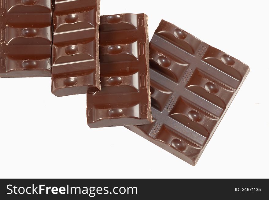 Slices of dark chocolate bar isolated on white background