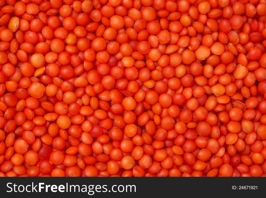 Bright red lentil is scattered in the background. Bright red lentil is scattered in the background