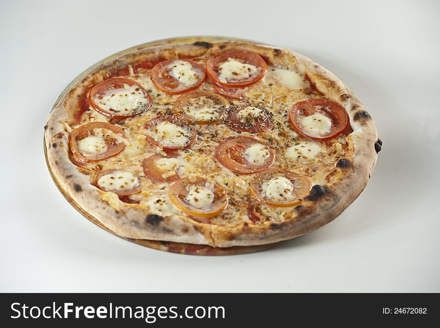 Pizza with mozzarela cheese and tomato. Pizza with mozzarela cheese and tomato.