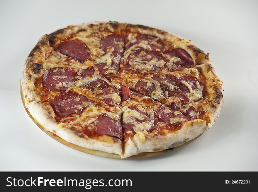 Pizza with salami and lots of cheese. Pizza with salami and lots of cheese.