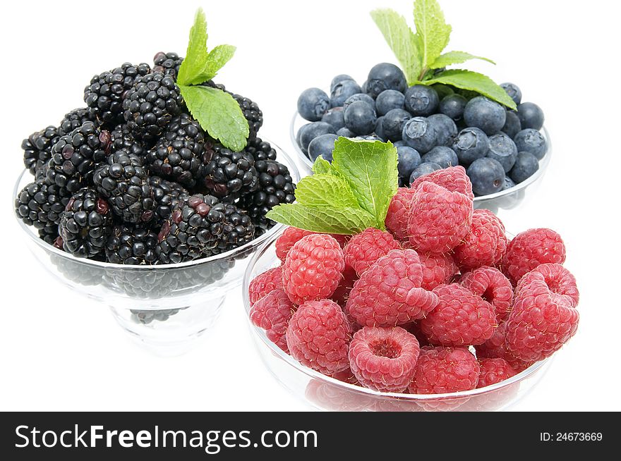 Blueberries raspberries and blackberries on a white background in the restaurant