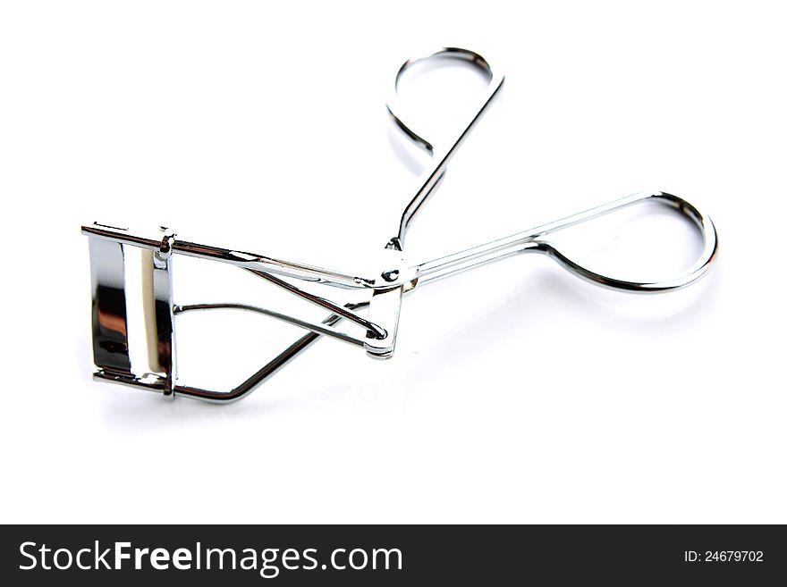 Eyelash curler on the white background