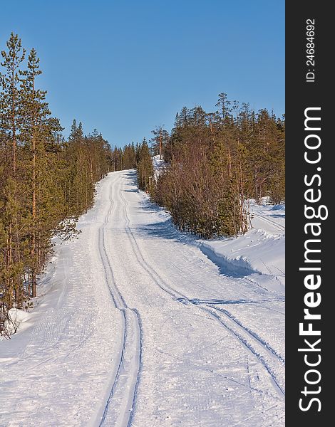 Freshly groomed empty cross-country ski track in woods. Freshly groomed empty cross-country ski track in woods