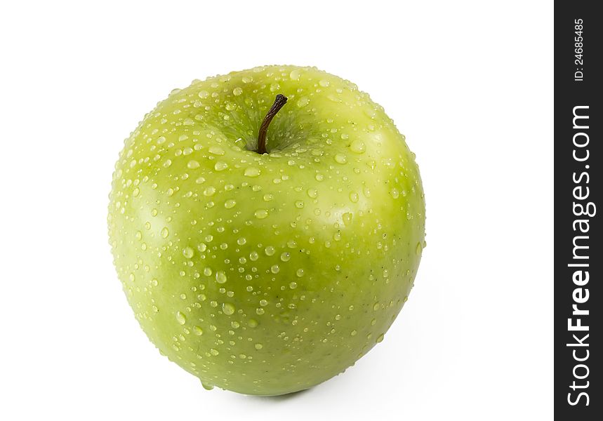 Green apple with drops of dew is isolated on a white background