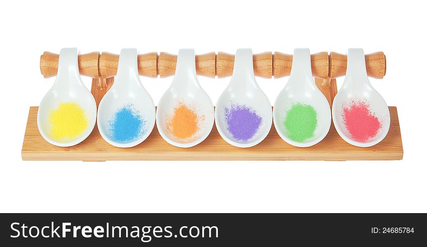 Porcelain, cerammic spoons on a wooden stand and condiments. Porcelain, cerammic spoons on a wooden stand and condiments.