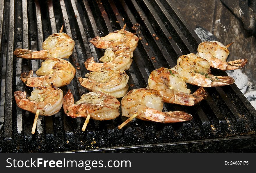 Cooking shrimp kebabs on the grill in the restaurant