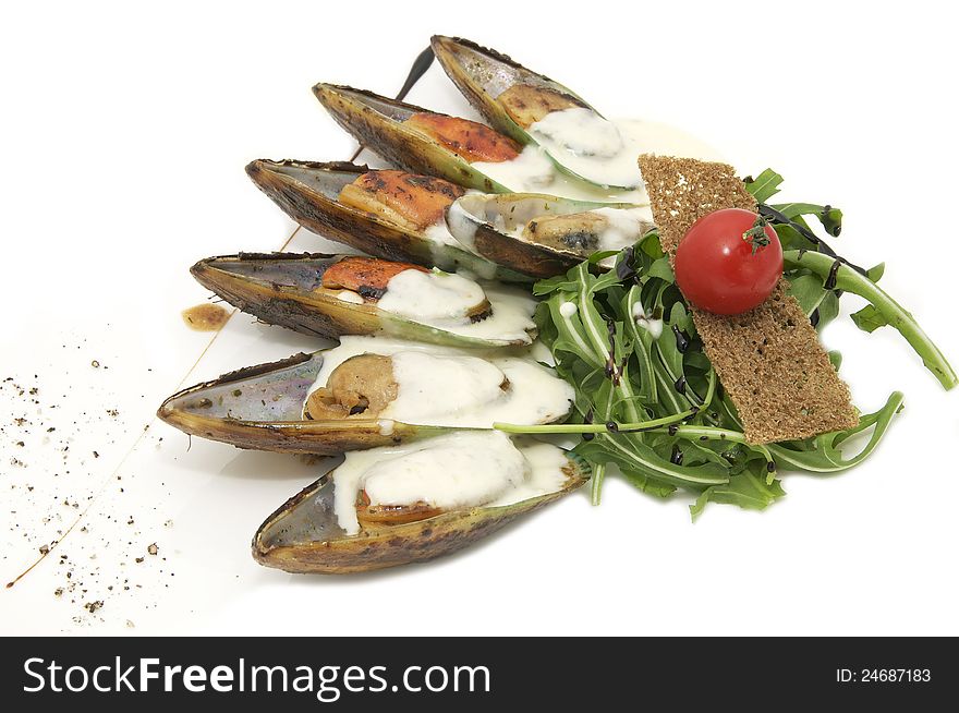 Mussels with sauce and greens on a white background