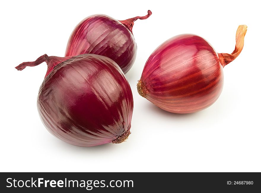 Three red onions against white background