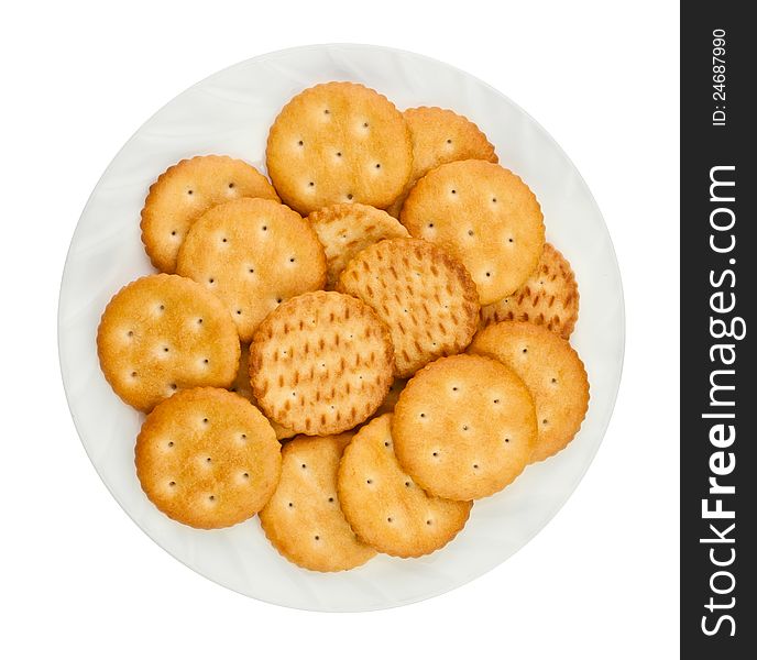 Heap of crackers on a plate against white background