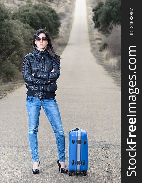 Woman in Lonely Road with Suitcase