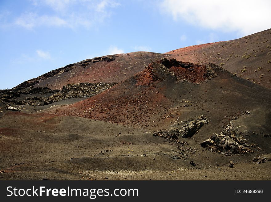 Volcanic landscape in Timanfaya National Park in Lanzarote (Canary Islands). The multiple volcanoes make the landscape look out of this world. Volcanic landscape in Timanfaya National Park in Lanzarote (Canary Islands). The multiple volcanoes make the landscape look out of this world.