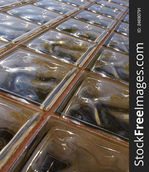 Background image featuring an outdoor wall of glass blocks in the sunlight. Background image featuring an outdoor wall of glass blocks in the sunlight.