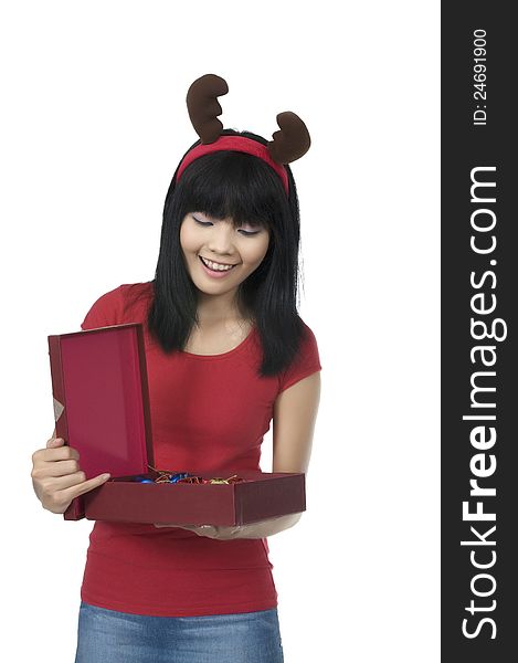 Beautiful asian woman holding christmas gift over white background. Beautiful asian woman holding christmas gift over white background