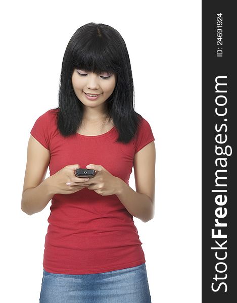 Young asian woman texting using cellphone isolated over white background