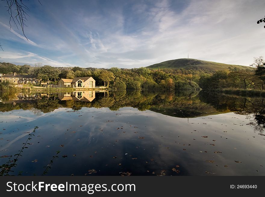 A reflection of house in water in a calm surroundings in Peak District. A reflection of house in water in a calm surroundings in Peak District