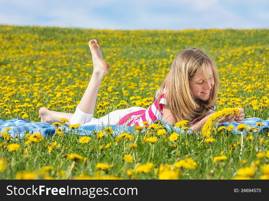 Teenage Girl Lying On A Dandelion Field