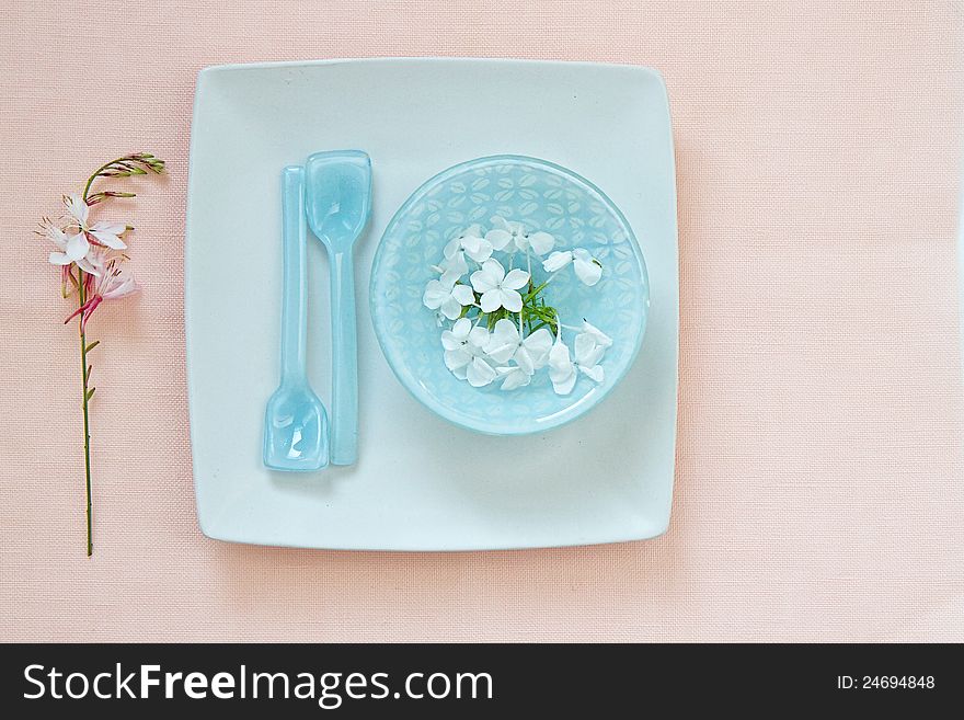 Table setting with glass bowl and flowers and space for text
