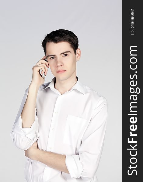 Young man talking phone on light background. Young man talking phone on light background