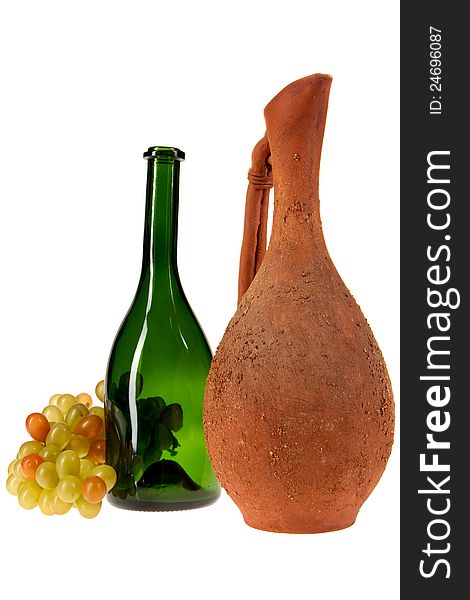 Pitcher, a glass bottle and a bunch of grapes on a white background. Pitcher, a glass bottle and a bunch of grapes on a white background