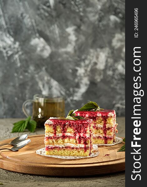 Delicious dessert biscuit with raspberries and green fragrant tea, home decor, gray background