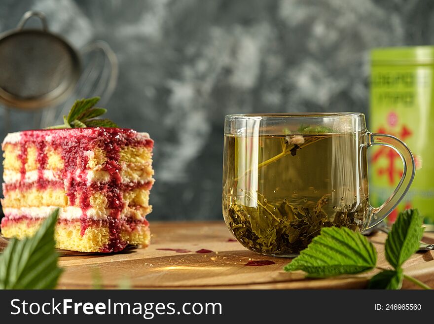 Delicious dessert biscuit with raspberries and green fragrant tea, home decor, gray background