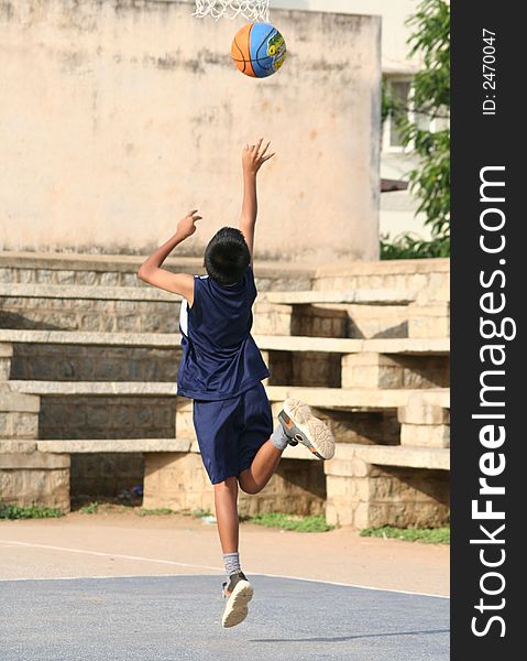 A young boy (10-12) trying to score a basket. A young boy (10-12) trying to score a basket