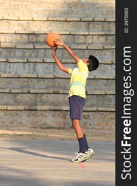 A young boy (10-12) trying to score a basket. A young boy (10-12) trying to score a basket