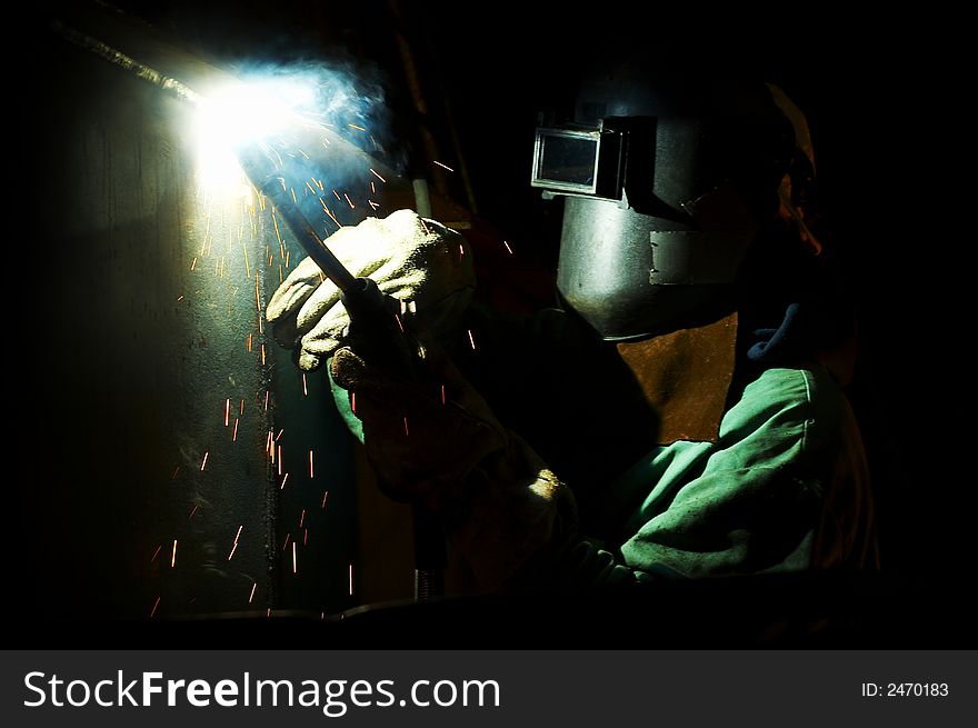 Welder under ship at night working. Welder under ship at night working