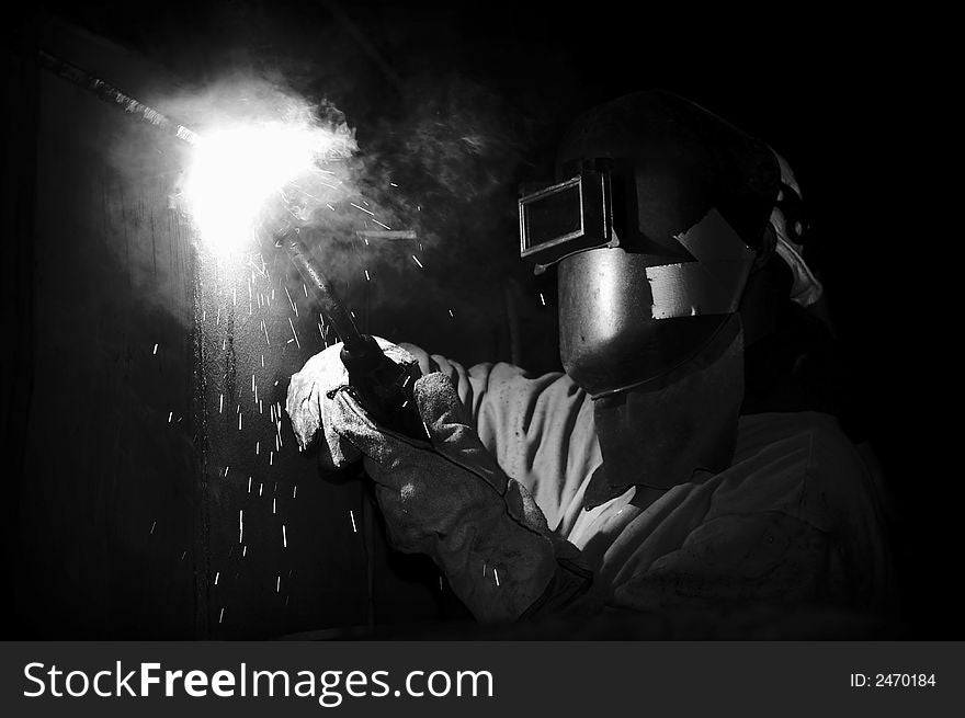 Welder under ship at night working. Welder under ship at night working