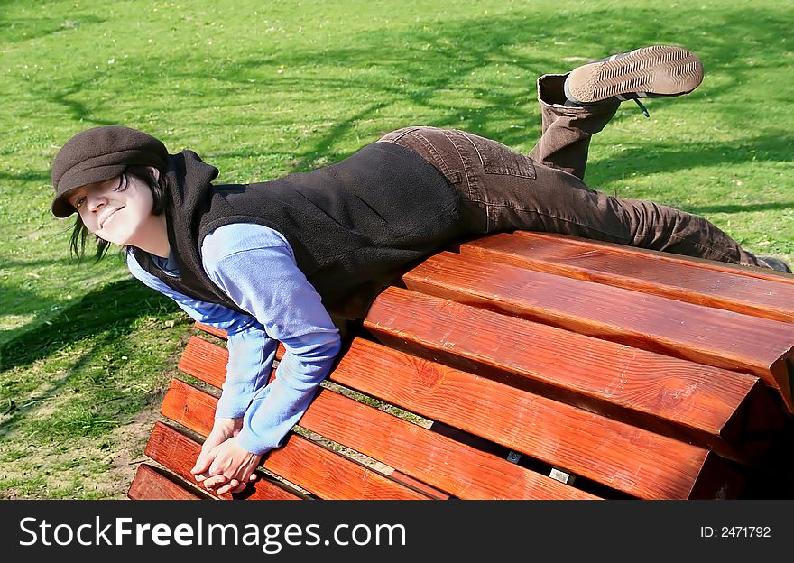 Girl having fun on wooden seat, outdoor, spring,