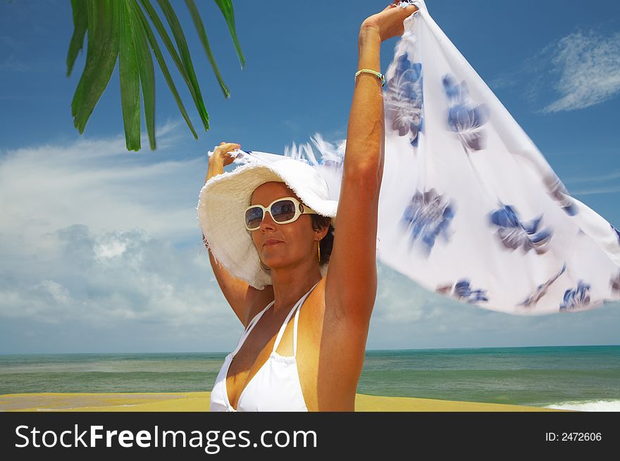 View of nice woman in white panama and bikini on tropical beach. View of nice woman in white panama and bikini on tropical beach