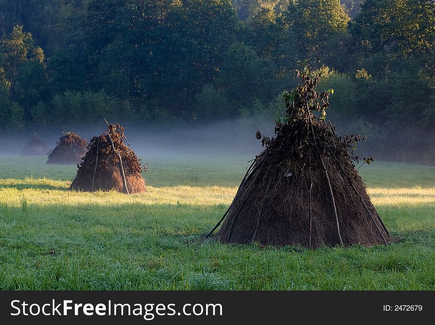 Three haystacks in the filed early morning